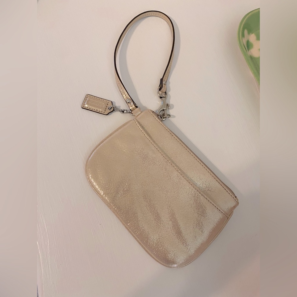 Coach wristlet. Soft gold material slightly shimmery.